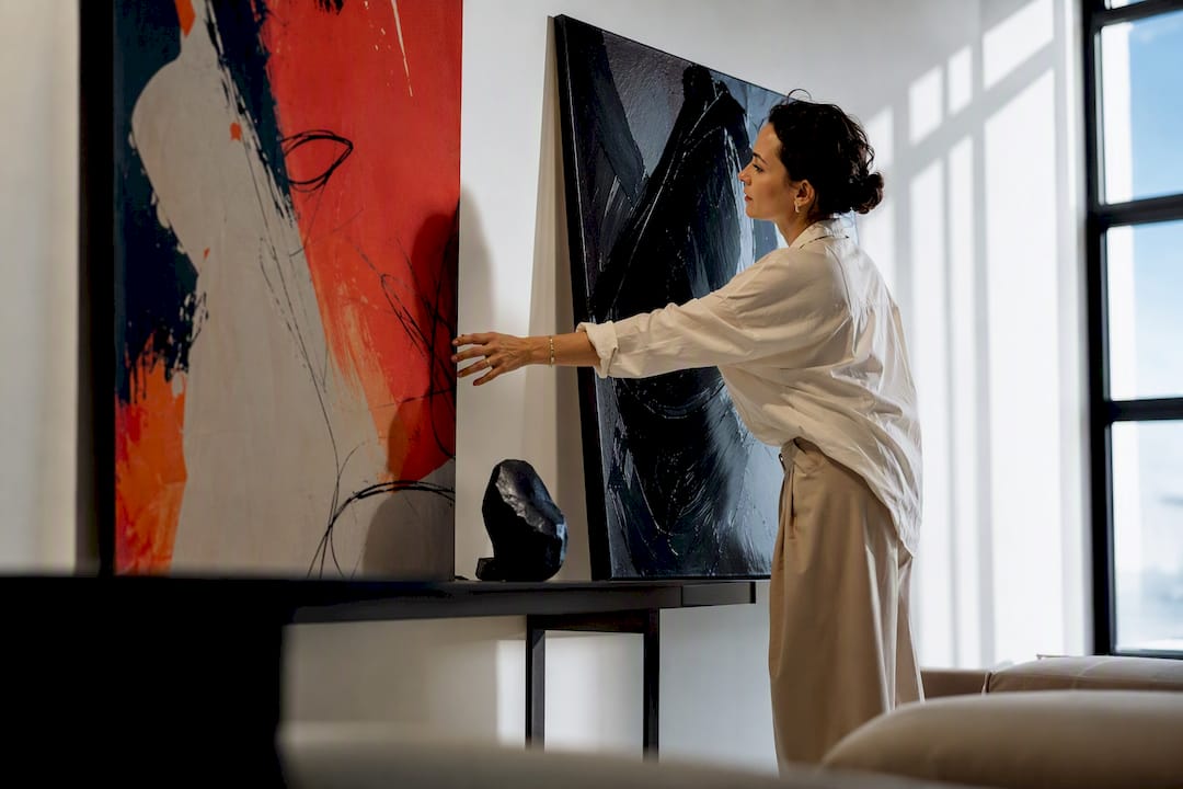 Stylist comparing fashion-inspired wall art