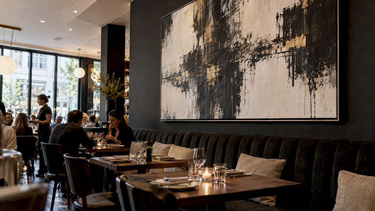 Statement canvas anchoring a restaurant dining room