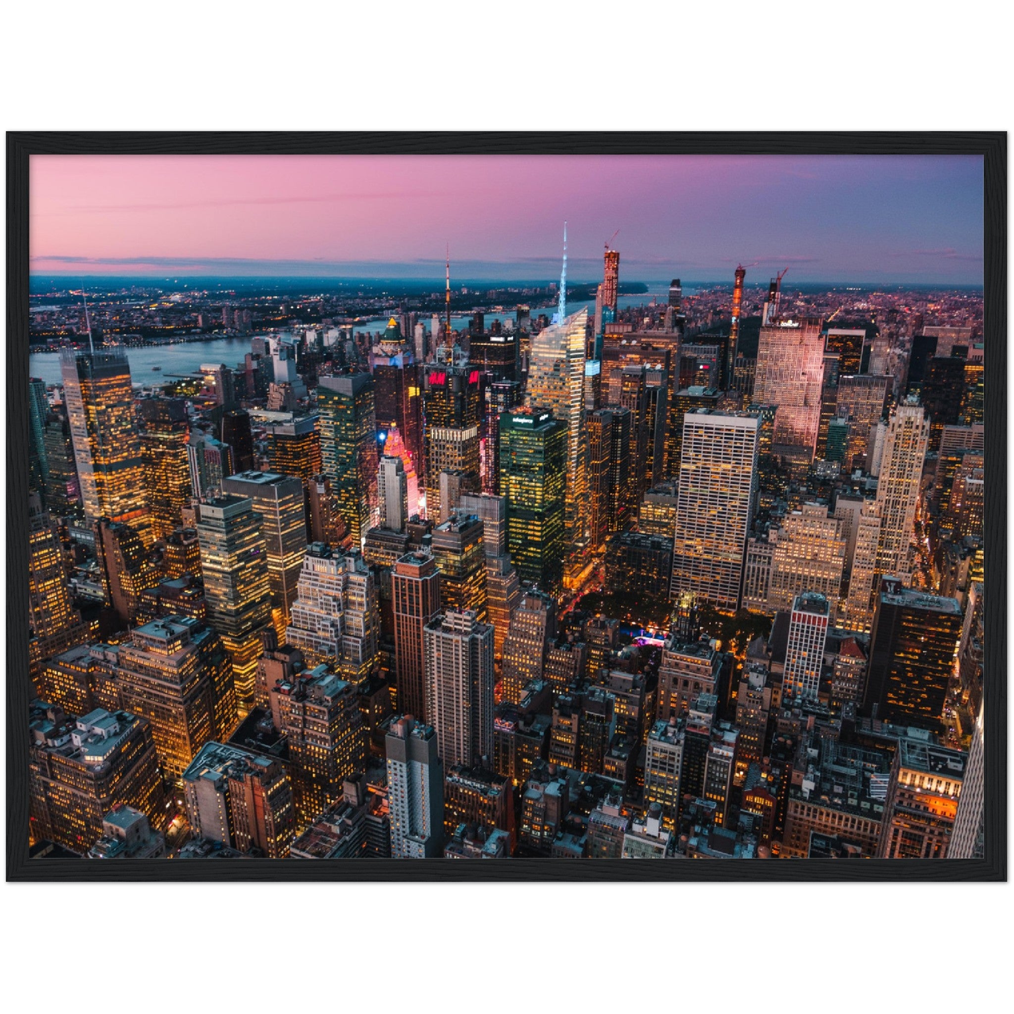 Manhattan Buildings Wall Art: Stunning aerial view of illuminated NYC skyscrapers at sunset. Perfect city skyline decor.