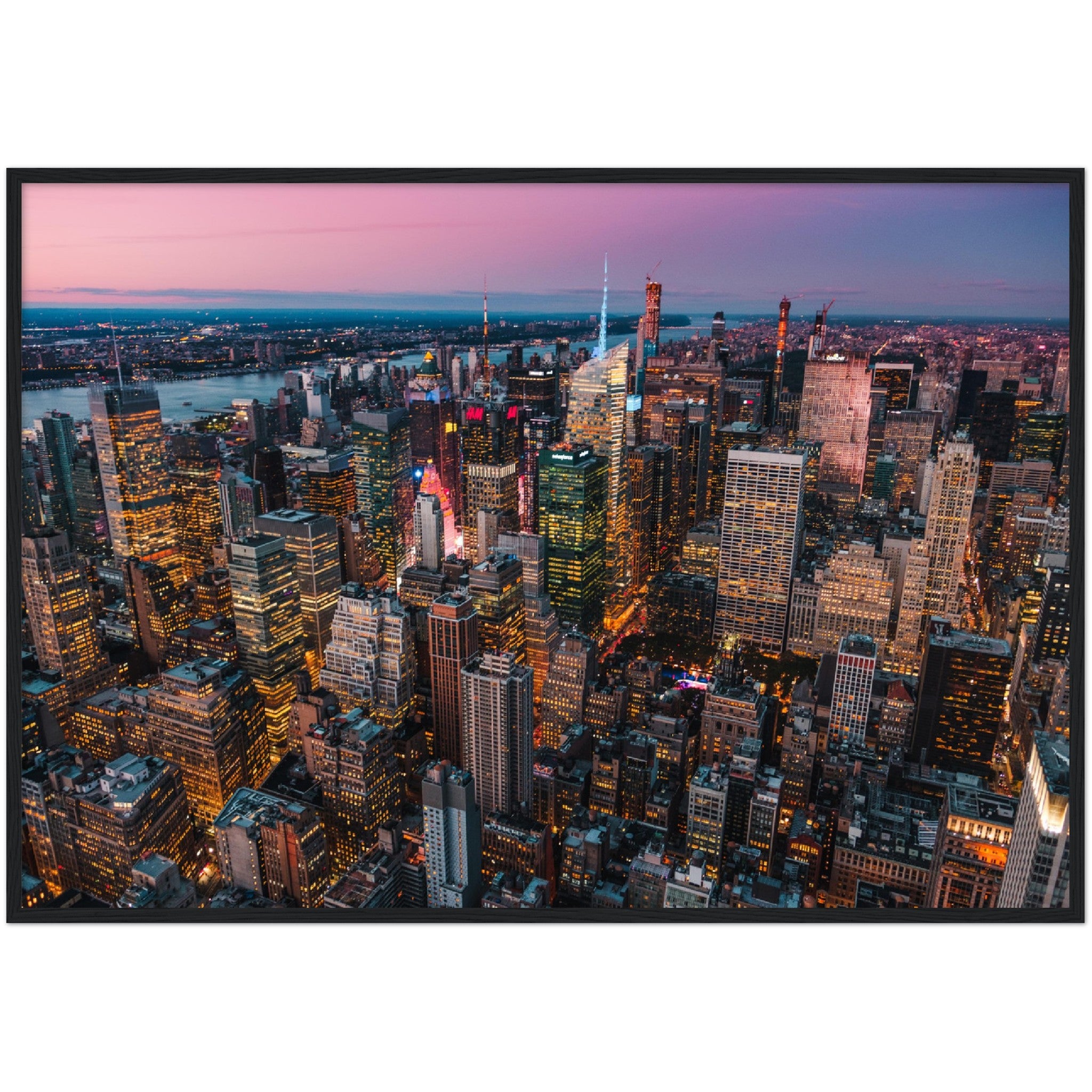 Manhattan Buildings Wall Art: Stunning aerial view of illuminated NYC skyscrapers at sunset. Perfect city skyline decor.