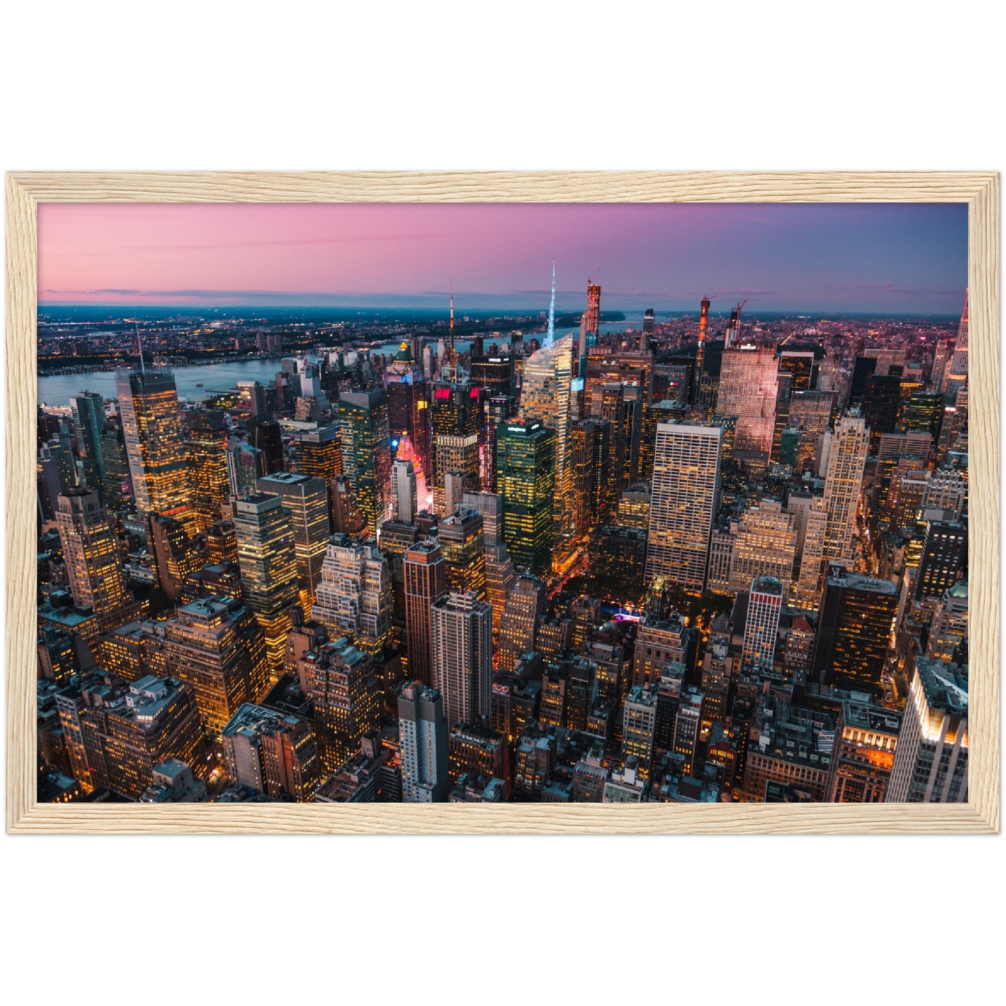 Manhattan Buildings Wall Art: Stunning aerial view of Midtown Manhattan at sunset, showcasing illuminated skyscrapers and city lights.