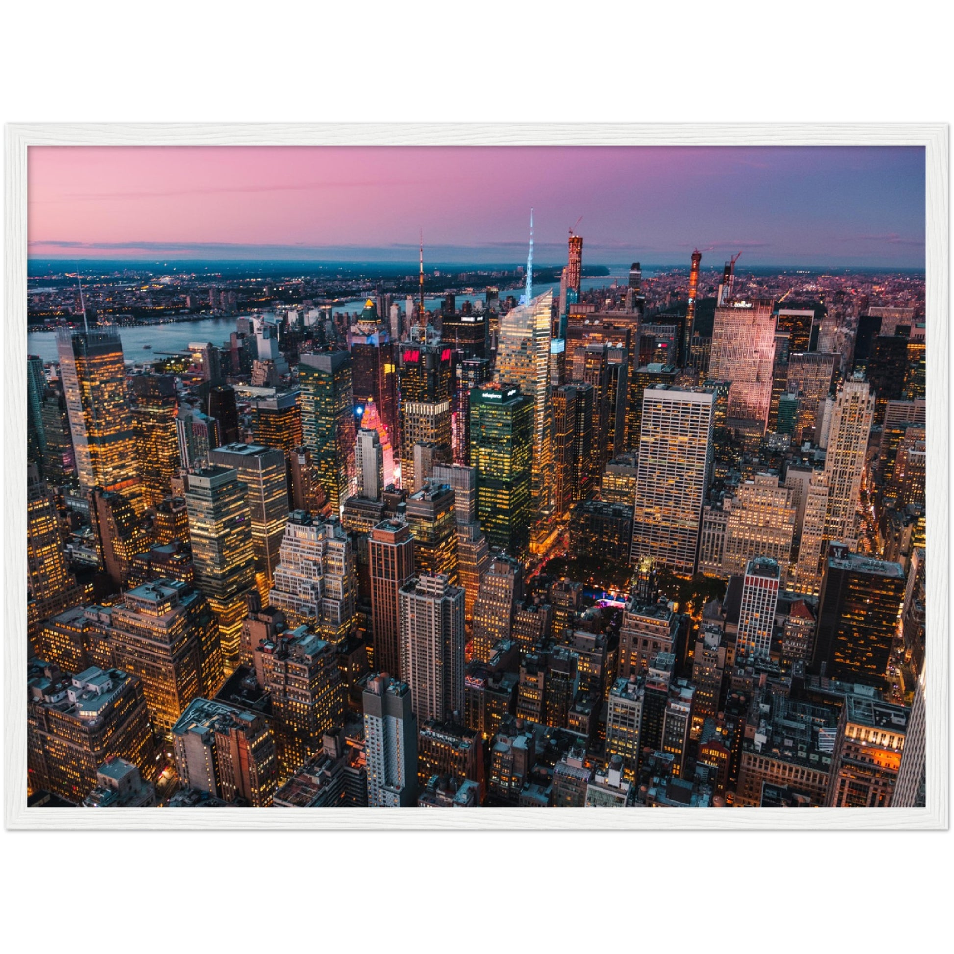 Manhattan Buildings Wall Art: Stunning aerial view of illuminated NYC skyscrapers at sunset.