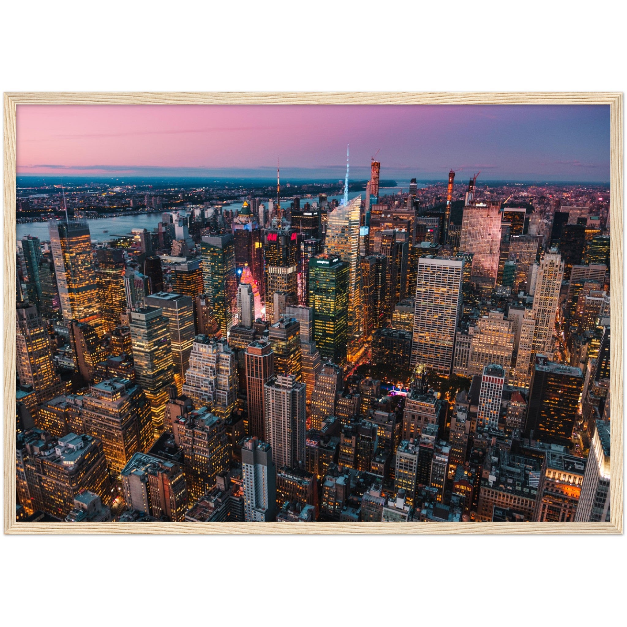 Manhattan Buildings Wall Art: Stunning aerial view of illuminated NYC skyscrapers at sunset.