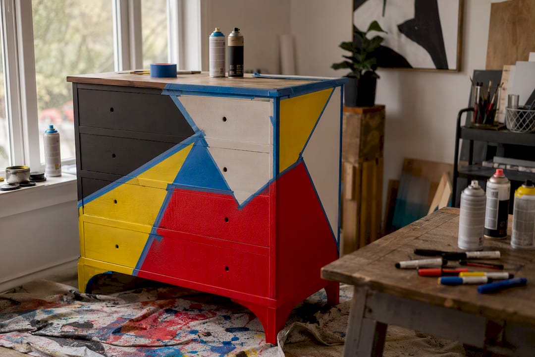 Close-up of pop art repainting on thrift dresser