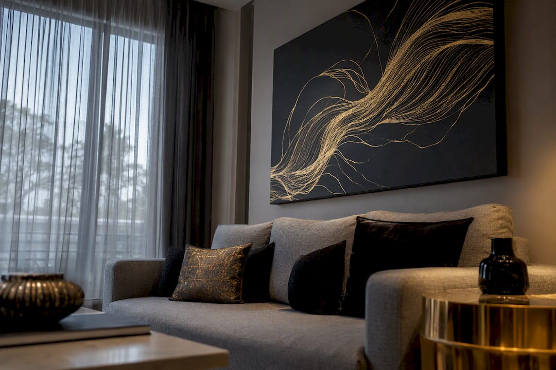 Modern living room with black and gold abstract canvas