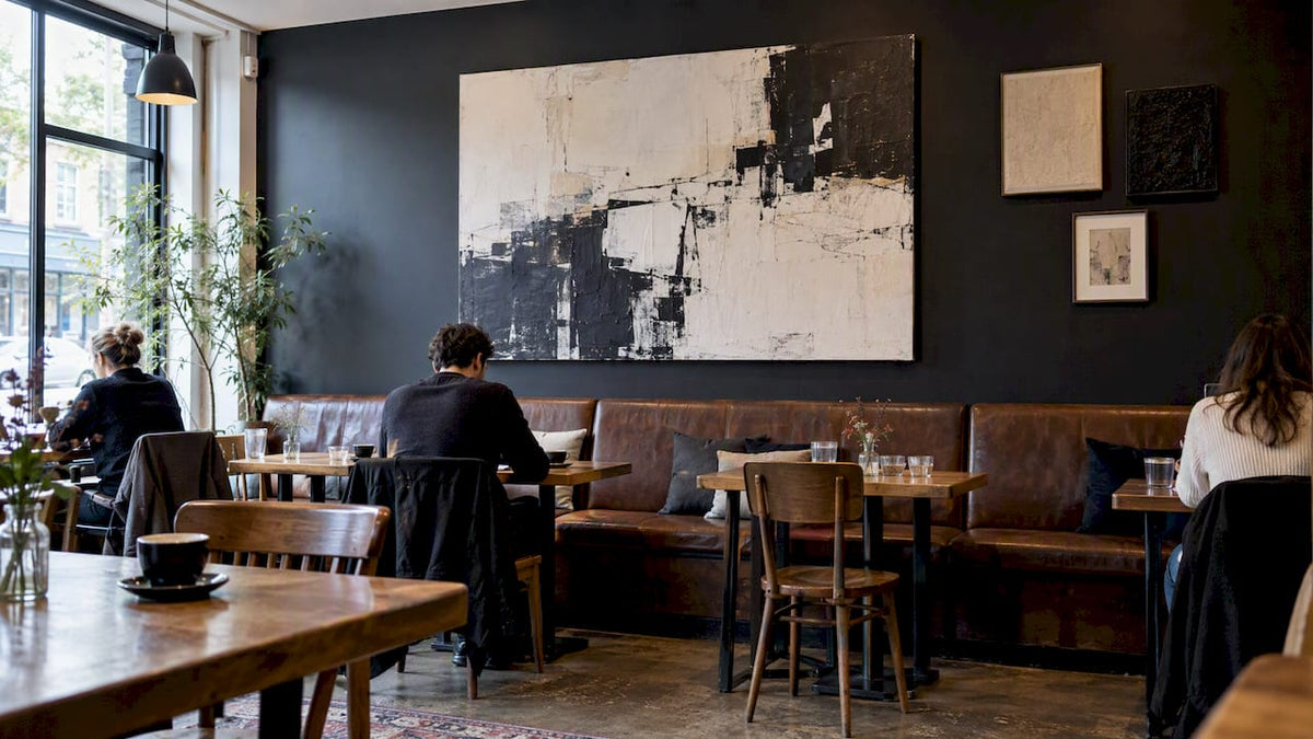 Bold canvas anchors a café seating wall